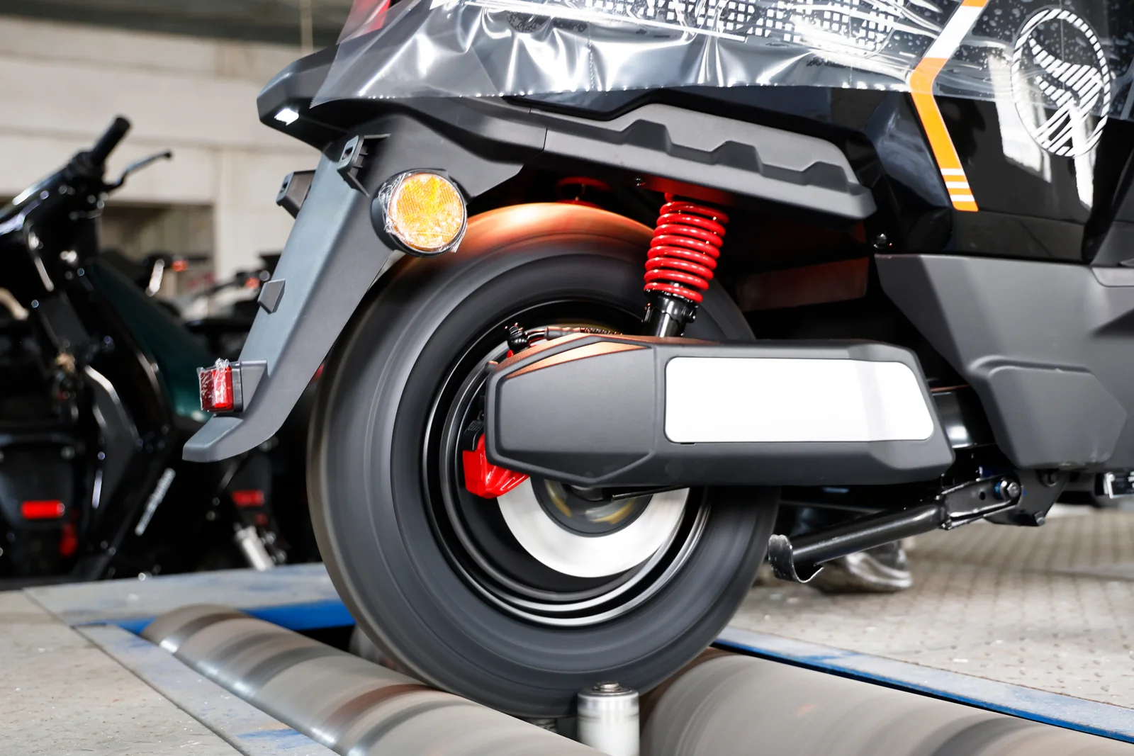 Rear wheel of a vehicle on inspection rollers
