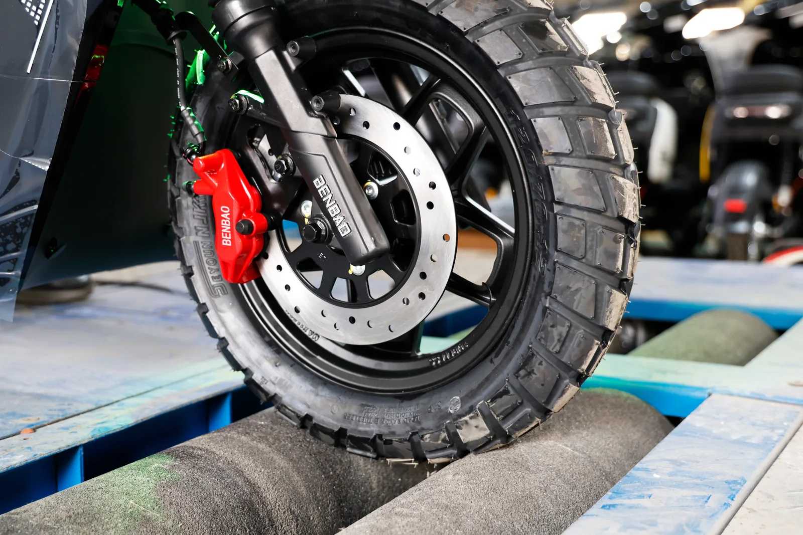 A vehicle wheel positioned on inspection rollers
