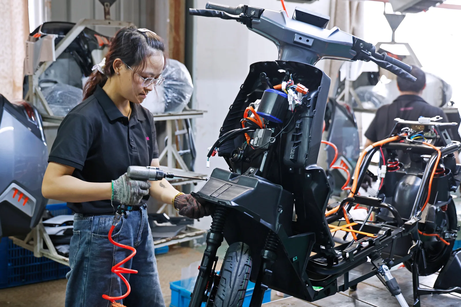 An operator working on a vehicle at an assembly station